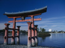Walt Disney Epcot Centre. A red Japanese Torri Gate on lake with Spaceship Earth seen from across water