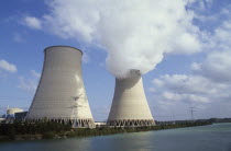 Nogent  Seine Valley.  Nuclear power station cooling towers beside water  emitting smoke