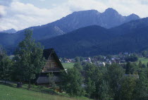 Tatra Mountain range with wooden chalet roof in the foreground.