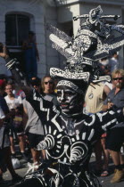 Notting Hill Carnival dancer dressed in a black and white costume and face paint