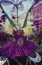 Notting Hill Carnival dancer in a purple costume.
