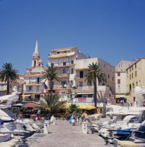 View along marina jetty toward the waterfront cafes and bars.Colorful