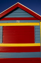 Detail of colourful painted wooden beach hut.