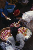 Woman selling sweets from market stall.