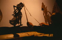 Wayang Kulit shadow puppet performance.  Puppet master or Dalang at work  he tells the story  speaks all the voices and conducts the gamelan music.
