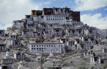 Tibetan Buddhist monastery and surrounding buildings set into steep hillside. Thikse