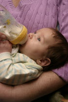 Kylan Stone  infant  drinking from baby bottle.
