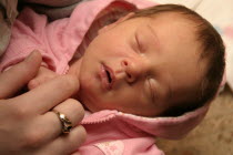 Kylan Stone  newborn baby girl holding mothers finger  10 days old.