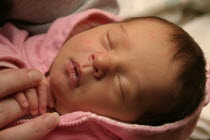 Kylan Stone  newborn baby girl holding mothers finger  10 days old.