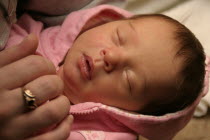 Kylan Stone  newborn baby girl holding mothers finger  10 days old.