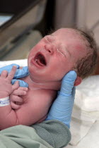 Kylan Stone  newborn baby girl being checked by nurse in hospital  crying.