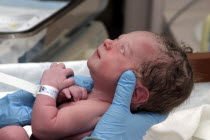 Kylan Stone  newborn baby girl being checked by nurse in hospital.