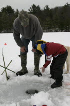 Father and Son Mike Stone and Tyler Stone ice fishing Meetinghouse Pond.   winter teaching