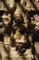 Carved Hindu iconography in Jain temple in Old City.  Close view disected by lines of shadow.