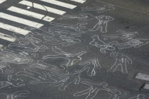 Chalk outlines with the names of participants in an event on Avenida Francisco de Miranda to protest increasing levels of violence.