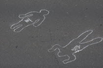 Chalk outlines with the names of participants in an event on Avenida Francisco de Miranda to protest increasing levels of violence.
