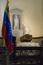 Coffin containing the remains of Simon Bolivar with Venezuelan flag in foreground  Panteon Nacional.
