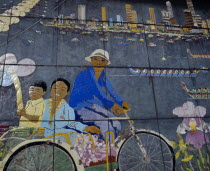 Painted mural depicting city skyline  dragon boat racing  orchids and trishaw driver.