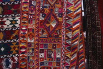 Detail of brightly coloured Bedouin textiles for sale at market.Colored