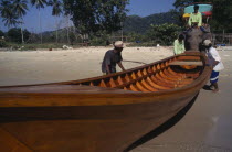 Elephant launching newly built longtail boat.