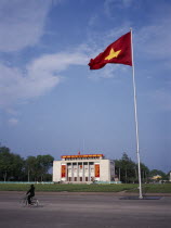 Ho Chi Minh Mausoleum and passing cyclist.