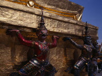 The Grand Palace.  Detail of figures encircling golden spire decorated with brightly coloured mosaic. Colored