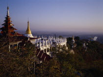 View south from Mandalay Hill over temple stupas and pagoda style roof.Burma Myanmar