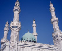 Iranian Mosque.  Part view of highly decorated facade of mosque showing domed roof and four minarets. Moslem Muslim