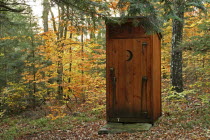 Outhouse amidst autumnal foliage.