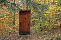 Outhouse amidst autumnal foliage.Fall Toilet Shed Loo