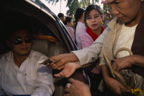 Donations being made to revered monk at Shwedagon Pagoda.Burma Rangoon Shwe Dagon Myanmar Yangon