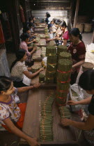 Line of female workers inside cheroot factory.Burma Pegu Bago Myanmar