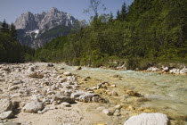 Looking along the Velika Pisnica towards Mount Prisank in the Julian Alps. There is still snow lying on the mountain after a severe winter  Clean waterclear blue waterPisn calimestone rocksJulian...