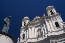Via Etna. Collegiate church of Santa Maria del Elemosina with angled view of exterior and statue