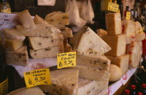 Market cheese stall with detail of a selection of cheeses and euro money price signs