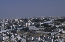 Elevated view over city architecture and The Security Fence which divides Israel from the West Bank