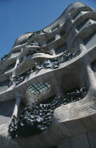 Casa Mila or La Pedrera by Antonio Gaudi  built 1906-1910.  Detail of exterior facade showing wave like stone walls and ironwork balconies. Catalunya