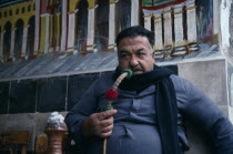 Man smoking traditional water pipe or hookah.sheesha