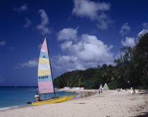 Sandy Lane beach  yellow hobie cat  people and yachts in distance