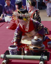 Woman in Court costume preparing the Tea Cermony