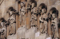 Benedictine Abbey of Jak. Detail of carved religious figures over stone archway.