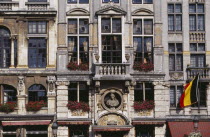 Grand Place.  Part view of building facade with stone balconies  flower filled window boxes and tall multi-paned windows.UNESCO World Heritage Site  UNESCO World Heritage Site