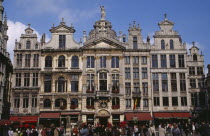 Grand Place.  Crowds in front of old town buildings and cafes.UNESCO World Heritage Site  UNESCO World Heritage Site