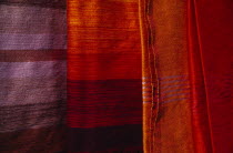 Detail of red  orange and blue woven textiles.