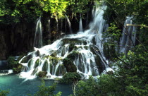 Plitvice lakes waterfall into lower lakes. Water follows the sinuous travertine  porous rock formation  line from the upper to lower lakes Croatian national parks