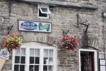 Detail of an Ice Cream Parlour in a traditional cottage with hanging basketsGreat Britain United Kingdom UK