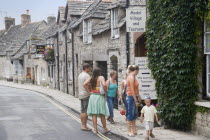 Visitors outside a Model Village and Tearoom shop in a row of traditional cottagesGreat Britain United Kingdom Store UK