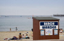 Beach Warden hut on sandy beach with sunbathers on the sandGreat Britain United Kingdom UK
