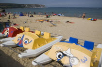 Colourful pedalo leisure boats painted with faces on sandy beachGreat Britain United Kingdom Colorful UK