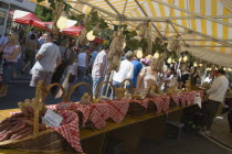 French Market. Yellow and white striped covered market stall with a selection of sausages and cured meat on display.Great Britain United Kingdom UK